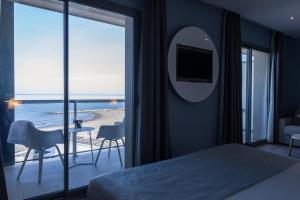 a bedroom with a bed and a view of the ocean at Hotel Vague d'or in Staoueli +66 photos