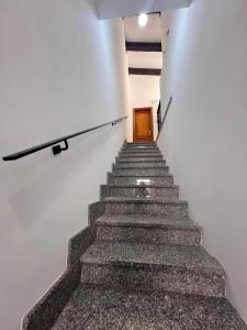 a staircase leading up to a door in a building at ROSSI SUITE Fco in Isola Sacra