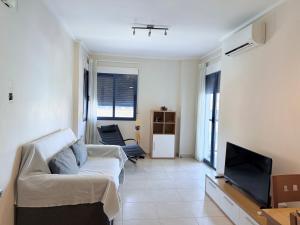 a living room with a couch and a flat screen tv at Alicante Hills 1 in Alicante