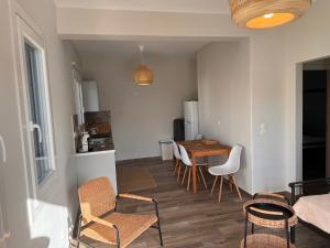 a kitchen and dining room with a table and chairs at Sea Sun Sand in Loutra