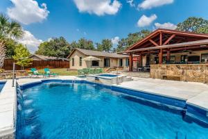 a swimming pool in the backyard of a house at DFW Large Vacation Retreat with Private Pool and Hot Tub in Irving
