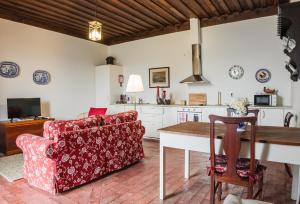 a living room with a couch and a table at Casa do Salgueiral in Santa Marta de Penaguião