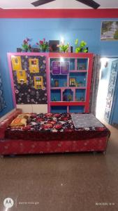 a bedroom with a bed with a head board at Linga Classic Homes in Kanchipuram