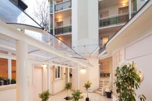 an internal courtyard of a building with potted plants at Au Pacific Hotel in Paris