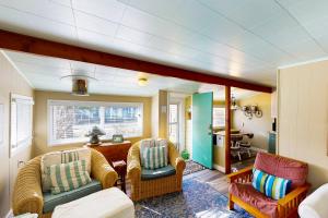 a living room with two chairs and a table at 4th Avenue Beach Cottage in Rockaway Beach