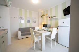 a kitchen and dining room with a white table and chairs at Onda del cielo in San Salvo +19 photos