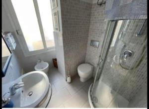 a bathroom with a shower and a sink and a toilet at A 10 passi dal mare in Ventimiglia