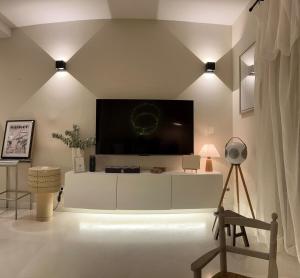 a living room with a large flat screen tv on a wall at Coconut, Anse Marcel, Beach & Pool in Anse Marcel 