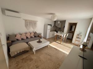 a living room with a couch and a table at Maison de vacances en campagne in Cavaillon +6 photos