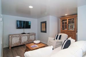 a living room with a white couch and a tv at 180 Walnut Lower in Carlsbad