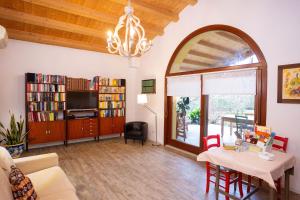 a living room with a couch and a table and a tv at "A casa di Jolanda" a green escape near Venice in Mestre