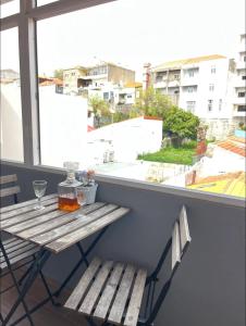 a table and two chairs on a balcony with a window at Apartamento centro histórico Porto in Porto +28 photos