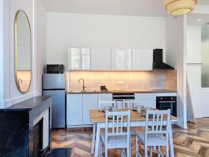 a kitchen with a table and two chairs and a counter at Gordes Centre-Historique téléphérique in Grenoble