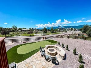 an outdoor patio with chairs and a fire pit at Falcon's Nest_hot tub_games_mins to USAFA and hiking in Monument