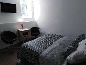 Postel nebo postele na pokoji v ubytování Tichý mlýn