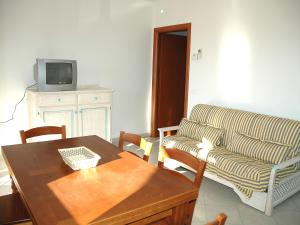 a living room with a couch and a table at Baia Fiorita in Porto Azzurro