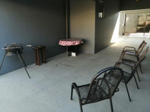 a room with three chairs and a table and a window at House grey proximo Holambra UNASP in Artur Nogueira