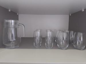 a row of clear glasses sitting on a shelf at House grey proximo Holambra UNASP in Artur Nogueira