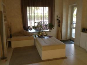 a living room with a couch and a window at Hotel C'era Una Volta in Castiglione della Pescaia