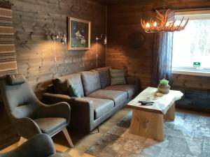 a living room with a couch and a coffee table at Ustedalen Lodge in Geilo