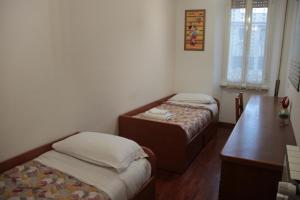 A bed or beds in a room at Dimora Re di Roma - Rome Apartment