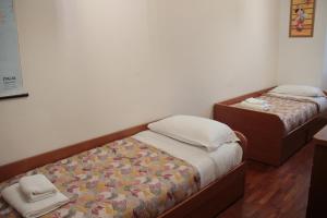 A bed or beds in a room at Dimora Re di Roma - Rome Apartment