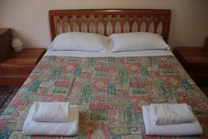A bed or beds in a room at Dimora Re di Roma - Rome Apartment