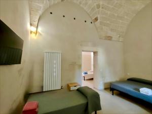 a living room with a bed and an arched ceiling at I Tre Pumi in Surbo +49 photos