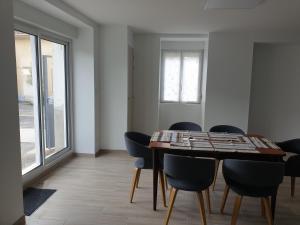a dining room with a wooden table and chairs at La petite Longère de Vin'Ay in Vinay