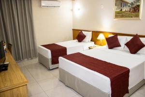 Ένα ή περισσότερα κρεβάτια σε δωμάτιο στο Hotel Dan Inn Araraquara by Nacional Inn