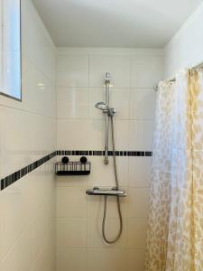 a shower in a bathroom with a shower curtain at Studio 41 Sunshine in Noordwijk aan Zee