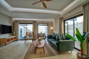 a living room with a couch and a table at Villa Savaaya Assagao Goa in Assagao