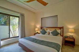a bedroom with a large bed and a large window at Villa Savaaya Assagao Goa in Assagao +84 photos