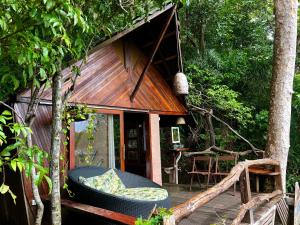a tree house with a porch and a deck at TerrAmor Ecoliving in Alter do Chao