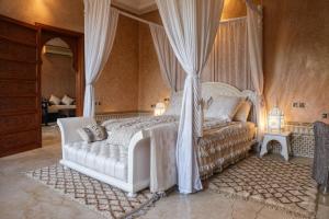 a bedroom with a white bed with a canopy at Luxury Private Villa Taj Sofia & Spa in Marrakesh