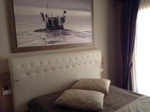 a bedroom with a bed and a picture on the wall at Hotel C'era Una Volta in Castiglione della Pescaia