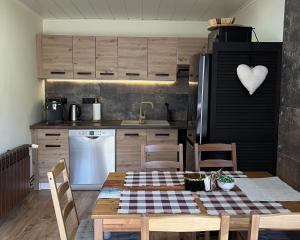 a kitchen with a table with a checkered table cloth on it at Ustronne Chatki - Górska Ostoja in Ustroń