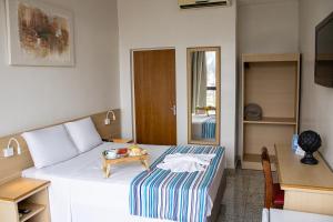 Postel nebo postele na pokoji v ubytování Hotel Dan Inn Barretos by Nacional Inn