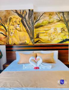 a bed with a painting of a lion on it at Sinhavilla Bentota in Bentota