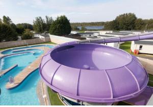 a view of a large pool with a water slide at McCanns Caravan Marton Mere in Blackpool
