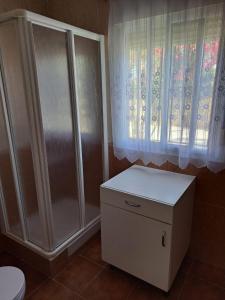 a bathroom with a shower and a toilet and a window at Villa Encanto Chiclana in Novo Sancti Petri +5 photos