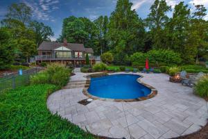 a patio with a swimming pool and a house at Ringneck Retreat in Mooresville