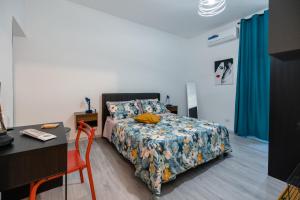 a bedroom with a bed with a table and a desk at Casa vacanza Francesca in Leonforte