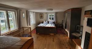 a bedroom with a bed in a room with windows at Ferienhaus Spreewaldnostalgie in Burg Kauper
