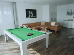a living room with a pool table and a couch at Luxury Apartment with Sauna - 185 m2 in Košice