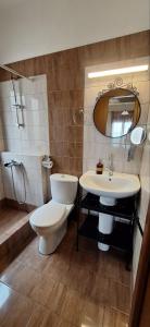 a bathroom with a toilet and a sink at DIOLKOS APARTEMENT in Nea Roda +32 photos