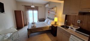 a small bedroom with a bed and a sink at DIOLKOS APARTEMENT in Nea Roda
