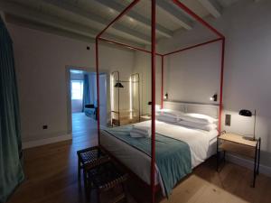a bedroom with a four poster bed with a red frame at LorPalma in Los Sauces