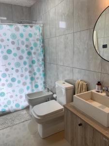 a bathroom with a toilet and a shower curtain at Costa Esmeralda Casa Ecu in Costa Esmeralda