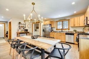 a large kitchen with a wooden table and chairs at Fish, Hike and Ski Spacious Family Escape in Eden in Eden